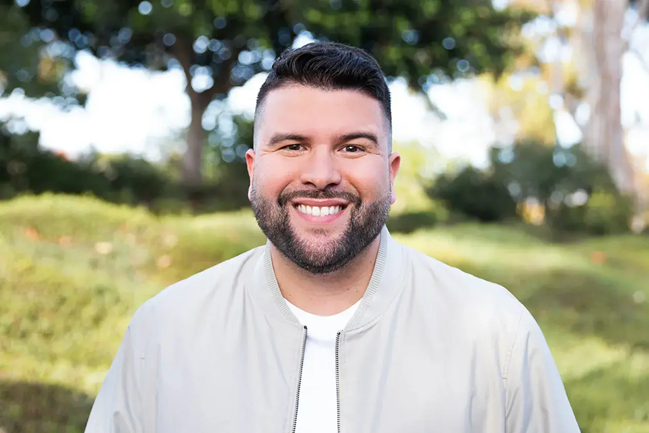A man with a beard smiling