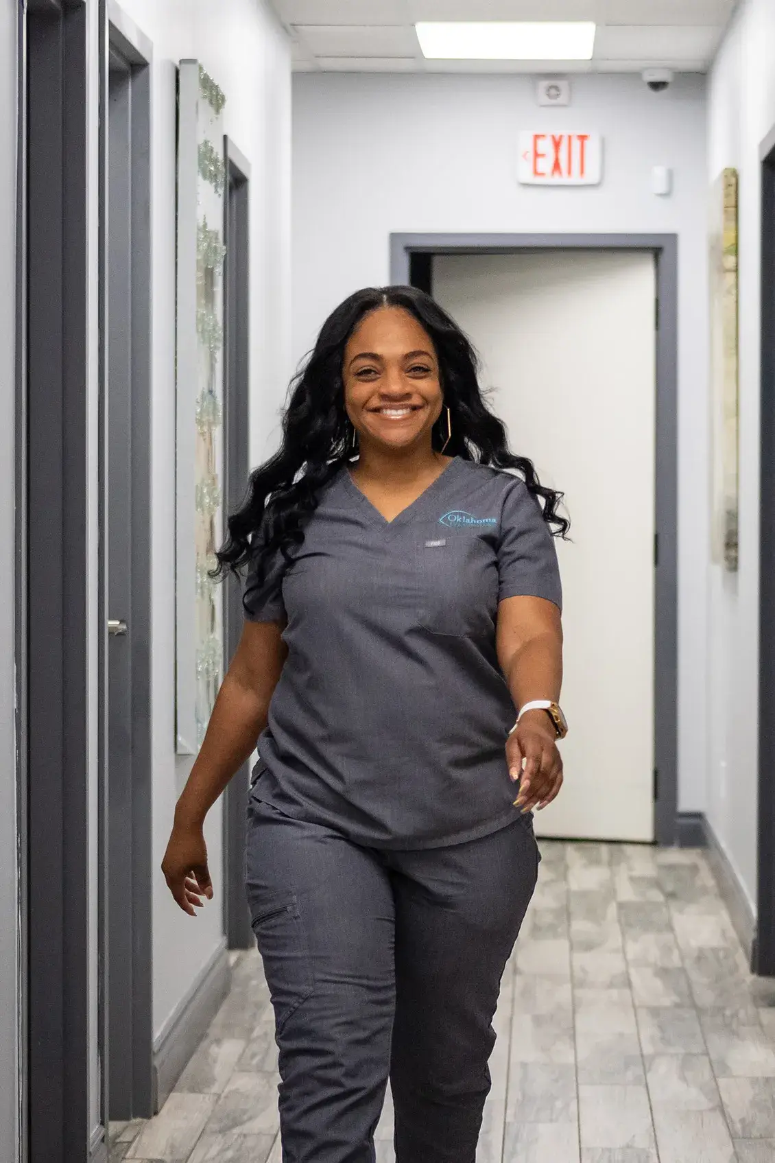 Team member smiling while walking down hallway
